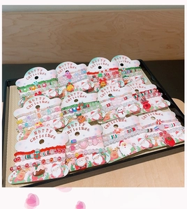 Detail of colorful Christmas beaded bracelets with Santa and elk charms on display cards