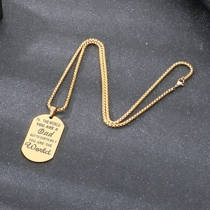 Detail view of golden stainless steel military tag pendant with Father's Day engraving