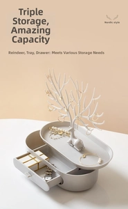 Detail of Nordic deer antler jewelry organizer with a white stand and gray storage drawer