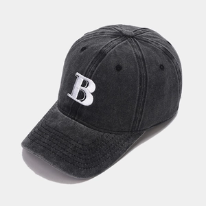 Detailed view of white letter B 3D embroidery on washed black cotton baseball cap