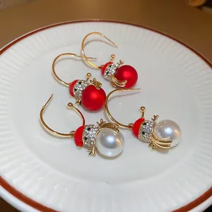 Detailed view of colorful rhinestone Christmas tree earrings in festive snowman design
