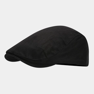 Side view of black cotton newsboy cap showing twill fabric texture and retro minimalist design