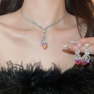 Close-up of sparkling heart pendant necklace and earrings set on an elegant model