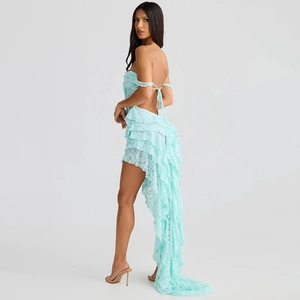 Detail of light blue lace dress with ruffle design and asymmetric long trail hem