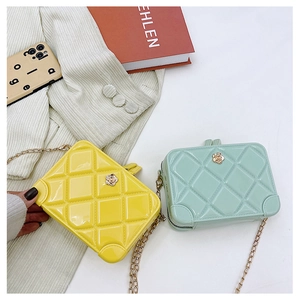 Detail of yellow and mint green quilted PVC jelly bags with gold chain straps and floral clasps