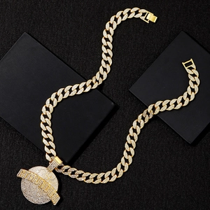 Close-up of a gold hip hop Cuban link necklace with a full iced-out planet pendant