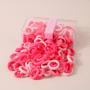 Close-up of assorted pink high-elasticity hair ties in a clear acrylic box packaging