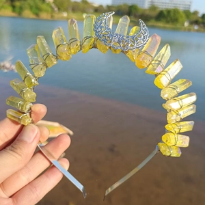 Detail of wire-wrapped yellow crystal points and metal moon on a handmade crown headband