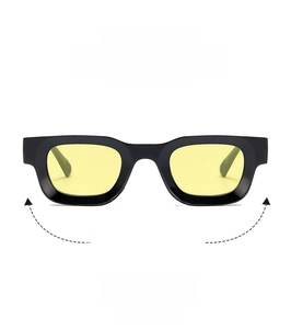 Detail of thick black rectangle frames with yellow lenses and sturdy hinges