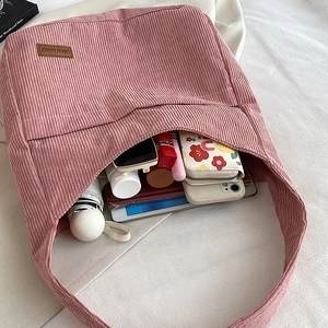 Pink corduroy tote bag with large capacity showing interior storage for daily essentials