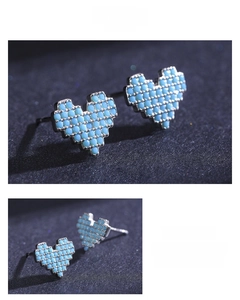 Macro detail of pixel heart stud earrings with inlaid turquoise blue beads in S925 silver