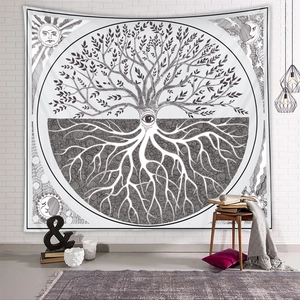 Detail of life tree tapestry on brick wall with bohemian moon and sun pattern