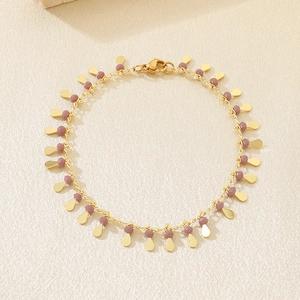 Detail of bohemian gold droplet charms and purple bead chain with lobster clasp
