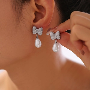 Bowknot pearl drop earrings with rhinestones and 18k gold plating on a silver base