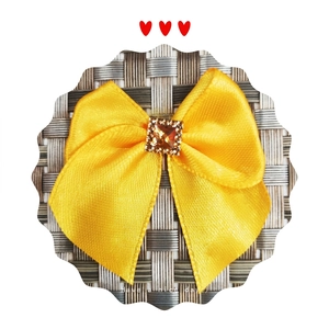 Yellow satin ribbon bow hair accessory with a sparkling orange square rhinestone center