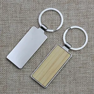 Rectangle bamboo wood and silver metal keychain with keyring on rustic burlap surface