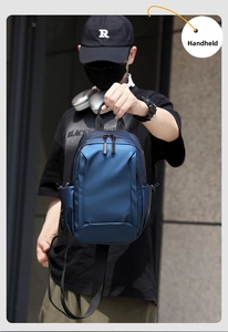 Detail of the navy blue waterproof crossbody bag featuring a durable top carry handle