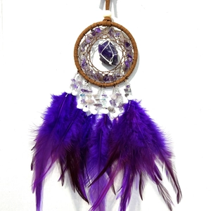 Detailed view of handmade dreamcatcher with amethyst stones and purple feathers decor