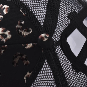 Detail of black leopard print sequins and breathable mesh stitching on baseball cap