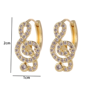 Detail showing musical G-clef earrings with white zircons and 2cm height dimensions