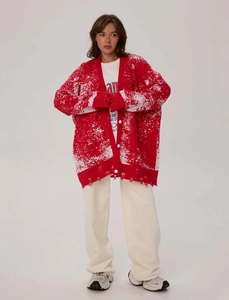 Detailed view of the red and white oversized knitted cardigan with distressed hem design
