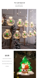 Close-up of LED Christmas tree light with Santa Claus motif and snowy bauble decor