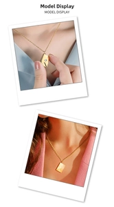 Detail of a gold envelope pendant necklace with a blue stone shown on a model