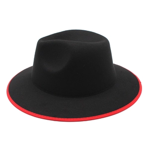 Detail of classic black wool fedora featuring a stylish red contrast binding on the flat brim