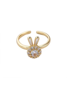 Detail of golden spinner ring with zircon rabbit motif and white enamel ears