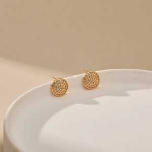 Close-up of 18K gold plated round stud earrings featuring shimmering zircon pave stones
