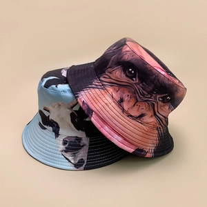 Reversible bucket hat featuring stylish cow and monkey prints on durable canvas fabric