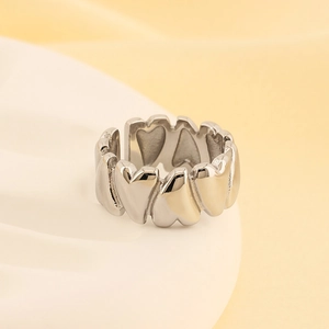 Detailed view of silver heart-shaped open ring with polished stainless steel finish