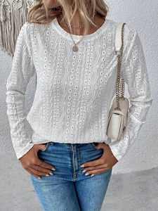 Detailed view of white hollow-out knit texture on this long-sleeve round neck top