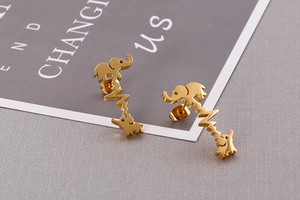 Detailed view of golden elephant and heartbeat line stainless steel stud earrings