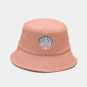 Detail of pink cotton bucket hat featuring shell embroidery and parallel brim stitching