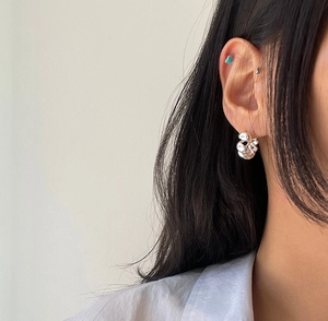 Detailed view of sterling silver twisted ear cuff and turquoise heart stud earring