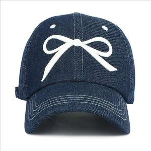 Classic dark blue denim baseball cap with white bow embroidery and curved brim