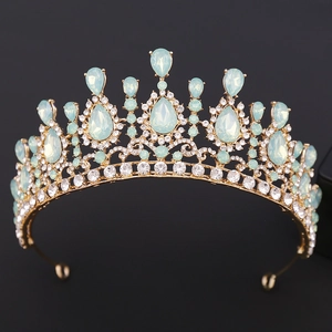 Close-up of golden bridal tiara featuring light blue teardrop crystals and clear stones