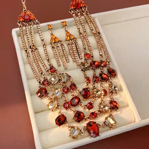 Vintage layered necklace with oval red crystals and matching earrings in a velvet gift box