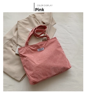 Pink corduroy tote bag with FASHION patch detail styled with a beige blazer