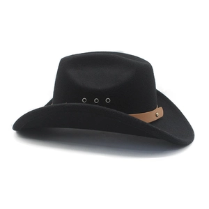 Detail of black western cowboy hat featuring brown leather band and metal eyelets