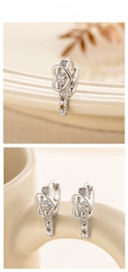 Macro shot of silver heart buckle earrings with white cubic zirconia pavé setting