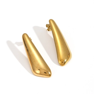 Macro view of mirror-polished gold teardrop earrings with a sleek minimalist metal finish