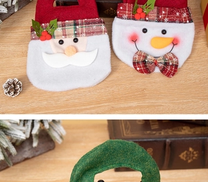 Detailed view of handmade felt Christmas gift bags with Santa and Snowman motifs