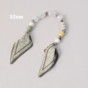 Close-up of a 32cm luxury pearl bead handbag strap with green silk scarf wrapping