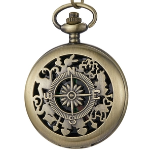 Detail shot of vintage bronze compass pocket watch cover with hollow-out design