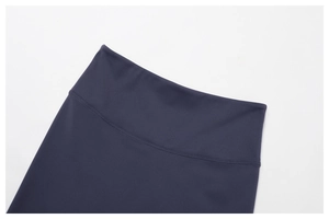 Detail showing high-waisted wide waistband on dark navy yoga leggings with flatlock seams