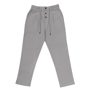Detail of grey cotton linen pants featuring elastic waist with buttons and drawstring