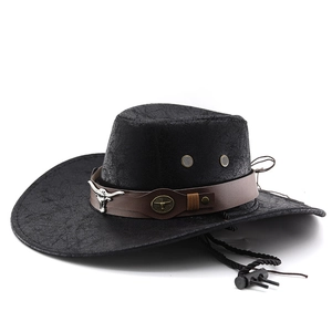 Detail of western cowboy hat with vintage bull head logo on a brown leather band