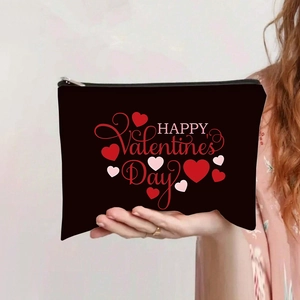 Detail of canvas makeup bag with Valentine's Day heart prints and black zipper closure